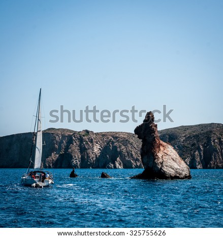 stock-photo-picture-of-a-boat-near-a-rabbit-shaped-rock-325755626.jpg